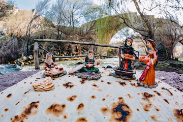 Souvenirs with armenian national clothing on armenian lavash