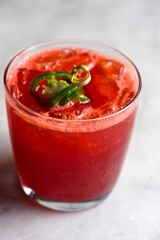 Margarita. Spicy Strawberry. Classic Mexican cocktail. Made with Blanco tequila, fresh lime juice, agave syrup and orange juice. Served in salt rimmed tumbler over ice and garnished with a lime.