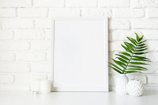 Poster template mock up with white vases and leaves on white brick wall background