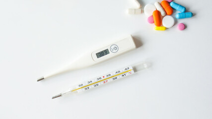 Thermometer old and new with some medicine