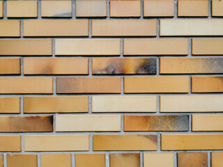 The wall is made of red bricks made from burnt clay. Vintage texture, urban background.