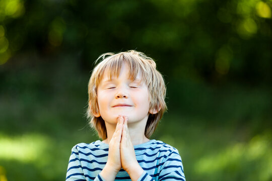 Boy praying with eyes closed