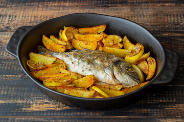 Dorado or sea bream baked with potatoes and lemon. Healthy eating. Diet.