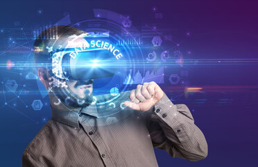 Businessman looking through Virtual Reality glasses with DATA SCIENCE inscription, innovative technology concept