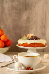 Christmas morning table with a cup of milk and festive cake in a background