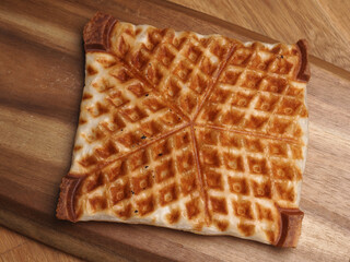 Waffle from puff pastry on a wooden board