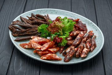 Traditional dry-cured sausage and jerky on a plate
