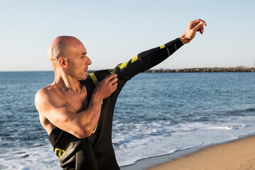 Swimmer putting on his wetsuit.