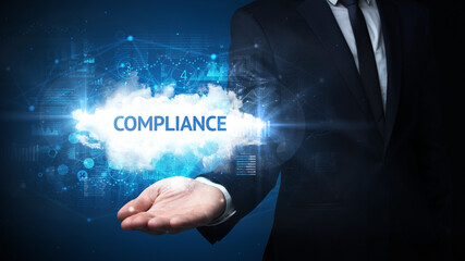 Hand of Businessman holding COMPLIANCE inscription, successful business concept