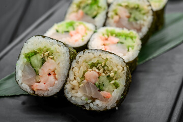 Sushi rolls, nigiri, raw salmon, pickled ginger. Asian food.