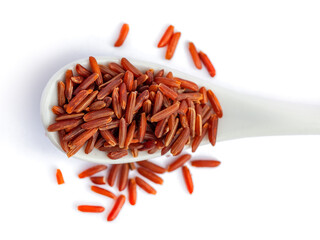 Heap of red rice on the ceramic spoon isolated on white background