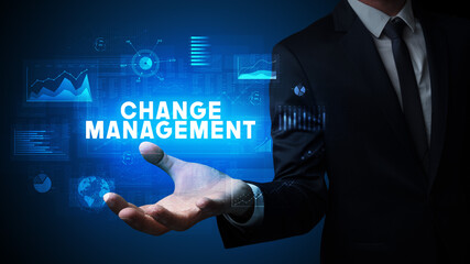 Hand of Businessman holding CHANGE MANAGEMENT inscription, business success concept