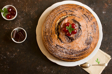 chiffon cake with chocolate and cherries
