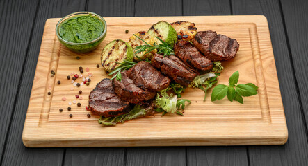 Grilled beefsteaks on cutting board - dinner preparation