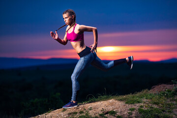 Determined Athletic Fitness Woman Running on Hills at Sunset