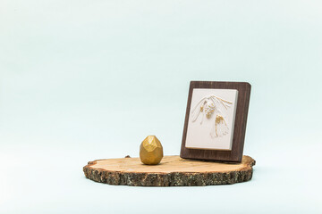 Trendy Easter lowpoly decor for design. Botanical bas-relief pine branch with cone on wooden platform and golden egg of geometric style. Happy Easter greeting card. Modern and luxury interior of room