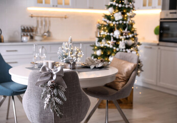Grey chair with beautiful Christmas decor in kitchen. Interior design