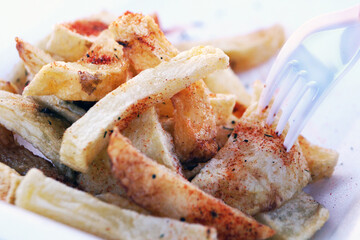 French fries on a plate with a fork, fast food
