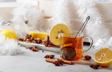 Christmas tea with spices on a white table.