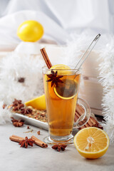 Christmas tea with spices on a white table.