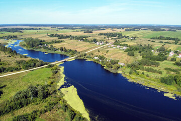 Aerial view of summer landscape with river and village