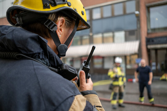 Firefighter talking via walkie talkie