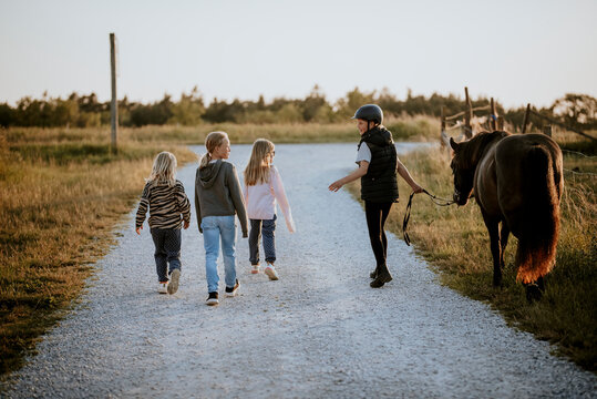 Girls talking on dirt road