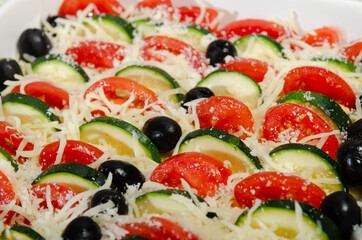 Casserole with cucumber, grated cheese, tomato and polenta,