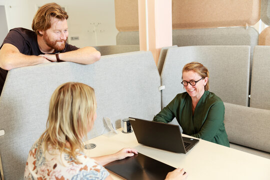 Coworkers talking at work