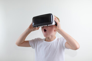 little boy in a white t-shirt with a virtual reality headset. on white background