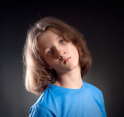 Portrait of a Boy with Long Hair in Blue Top. - 398764340