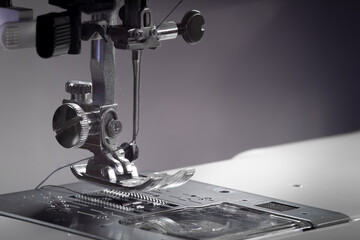 Metallic sewing machine foot. Studio light macro photo