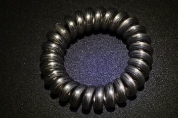 hair spring on black background