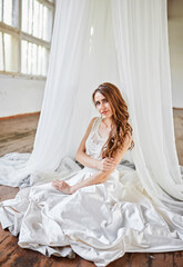 Fototapeta premium Bride in a white tent in a loft studio