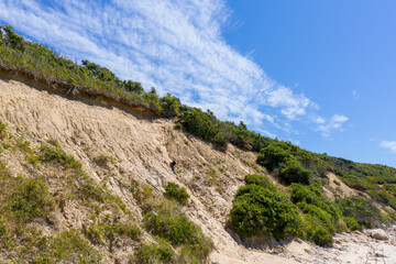 eroded cliff from the base with sky in background