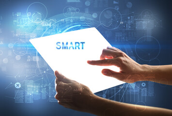 Hand holdig futuristic tablet with SMART inscription, new technology concept