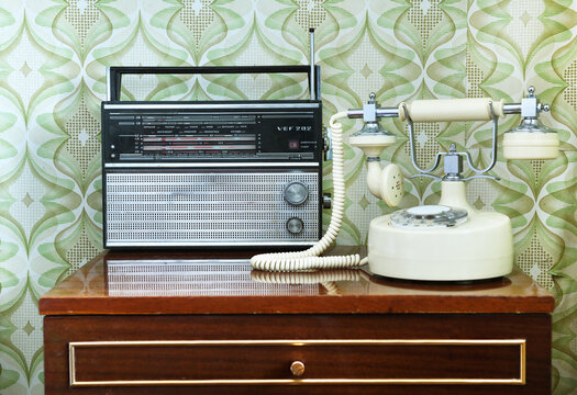 MINSK BELARUS-22.04.2020:Portable radio receiver "VEF-202" from I-quarter 1971 of production Riga Electrotechnical Plant "VEF".Antique radio on the nightstand in the room.