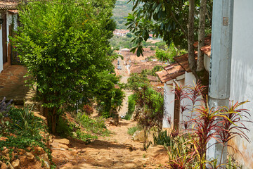 small historic alleyway with sandstone cobble stone in the historic colonial town of Barichara in Colombia, a popular touristic travel destination in andes mountains, south america
