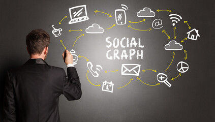 businessman drawing social media icons with SOCIAL GRAPH inscription, new media concept