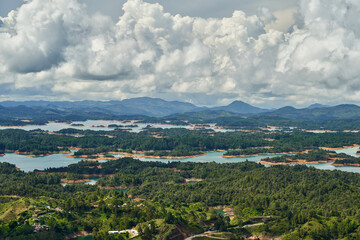 Fototapeta na wymiar View of Guatape from the top of El Penon onto the artificial lake with its turquoise water and lagoons