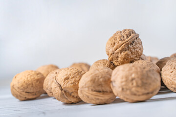 Walnuts kernels on white wooden desk, stock photo