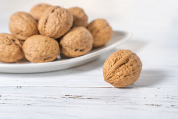 Walnuts kernels on white wooden desk, stock photo