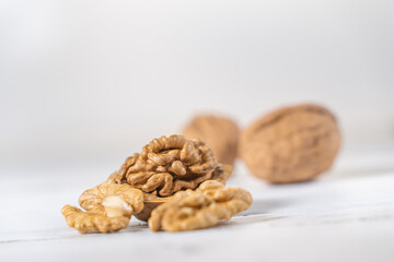 Walnuts kernels on white wooden desk, stock photo