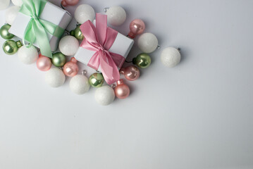 White gifts with pastel mint and pink ribbons. Set of gift box isolated on white background.Christmas gift boxes on white background. Beautiful Christmas background with shiny balls and ribbons.
