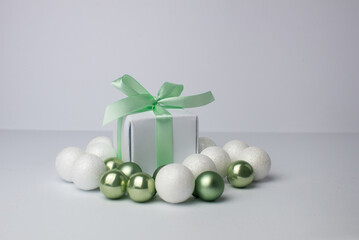 White gifts with mint ribbons. Set of gift box isolated on white background.Christmas gift boxes on white background. Beautiful Christmas background with shiny balls and ribbons in pastel mint color.