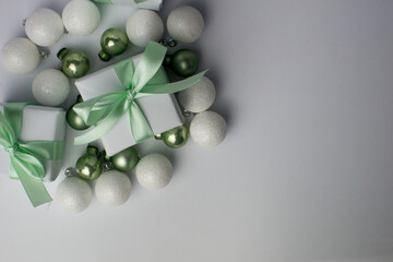 White gifts with mint ribbons. Set of gift box isolated on white background.Christmas gift boxes on white background. Beautiful Christmas background with shiny balls and ribbons in pastel mint color.