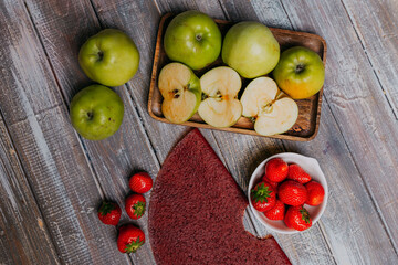 Strawberry fruit leather with fresh fruits on the wooden table. Round fruit leather. Healthy food. Apples, bananas, strawberries top view.