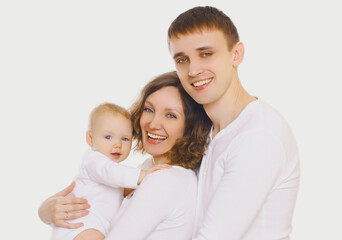 Family portrait of happy smiling mother, father and baby over a white background