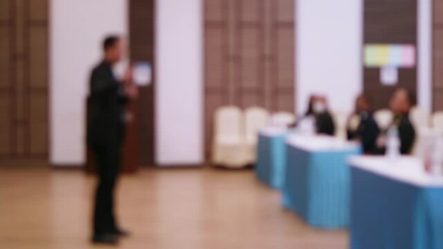 Blurring of the conference, seminar, training in the hotel meeting room with speakers lecturing