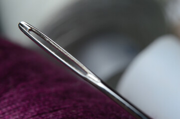 sewing needle on the background of a bobbin of thread. macro.